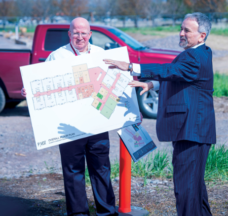 KCC President Dr. Roberto Gutierrez, right, and Director of Grant Resources Peter Lawson, host a tour of the childcare learning center worksite on campus Thursday for the public.